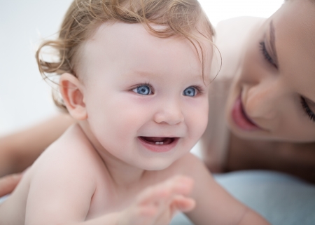 Smiling baby boy playing with his mother の写真素材