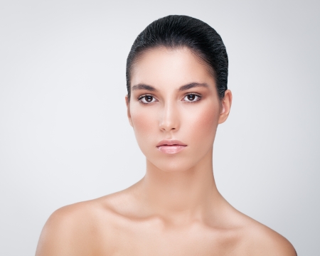 Portrait of a sensual Caucasian woman posing against a gray background.の写真素材