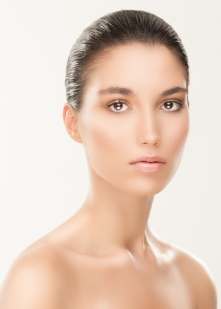Portrait of a sensual Caucasian woman posing against a gray background.の写真素材