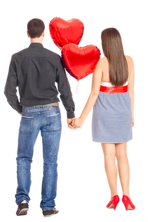 Couple in love holding hands and heart-shaped ballons.の写真素材