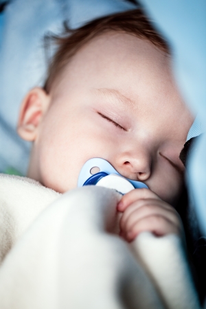 Close-up of an adorable baby sleeping peacefully in bed の写真素材