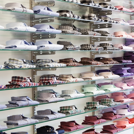 A selection of shirts for men in a boutique.の写真素材