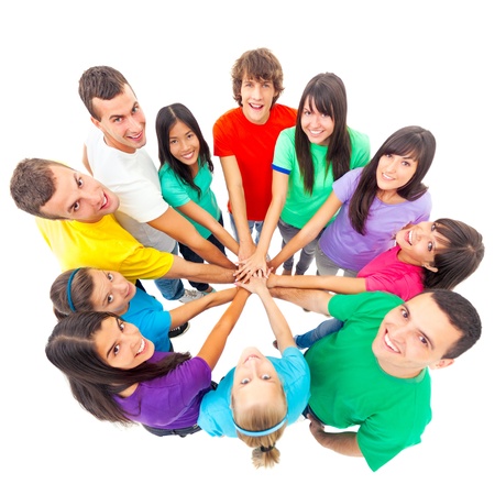A group of cheerful people showing their unity by putting their hands one on top of the other.の写真素材