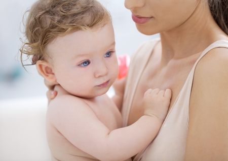 A mother holding her cute baby boy.の写真素材