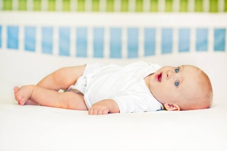 Cute baby boy lying on back.の写真素材