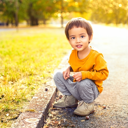 Cute smiling boy playing in the park.の写真素材