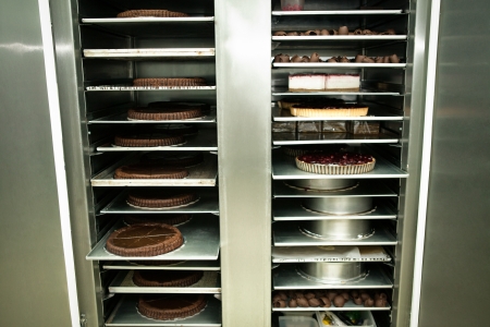 Large cake-shop refrigerator full of cakes.の写真素材