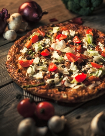 Delicious pizza on a wooden surface.の写真素材