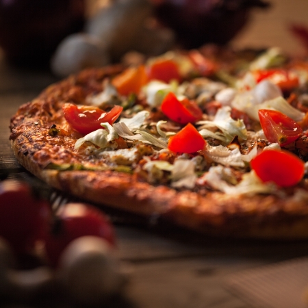Delicious vegetarian pizza on a wooden surface.の写真素材