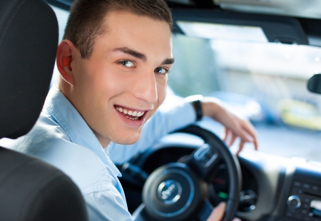 Young man driving his car.の写真素材