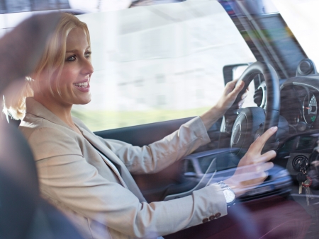 Beautiful mid-adult woman driving her car.の写真素材