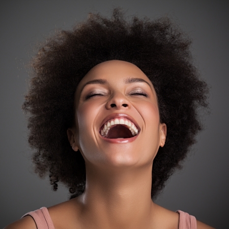 Portrait of a beautiful African woman laughing.の写真素材