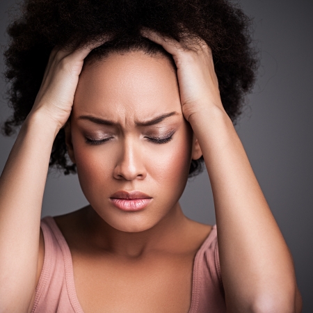 Young African woman suffering from a terrible headache.の写真素材