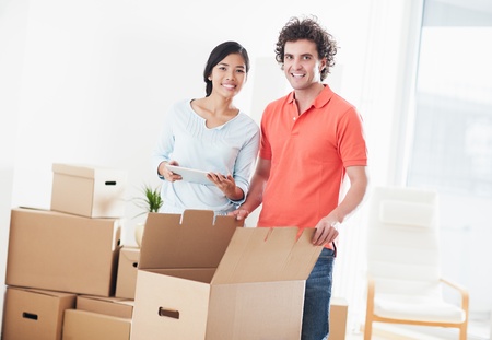 Young multi-ethnic couple moving into their new home.の写真素材