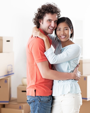 Young multi-ethnic couple moving into their new home.の写真素材