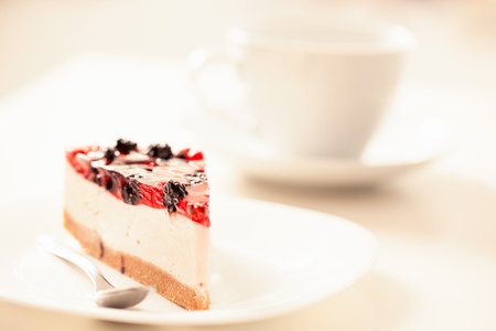 Slice of cheesecake and a cup of tea.の写真素材