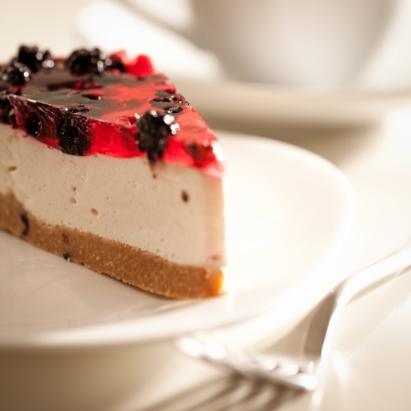 Slice of cheesecake and a cup of tea.の写真素材