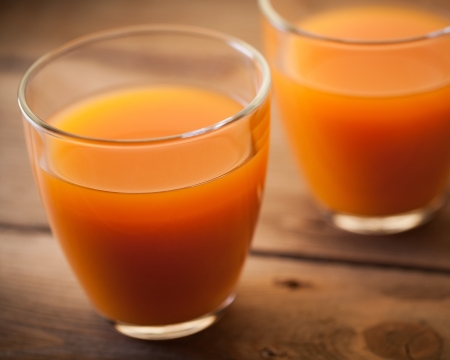 Two glasses of orange juice in close-up.の写真素材