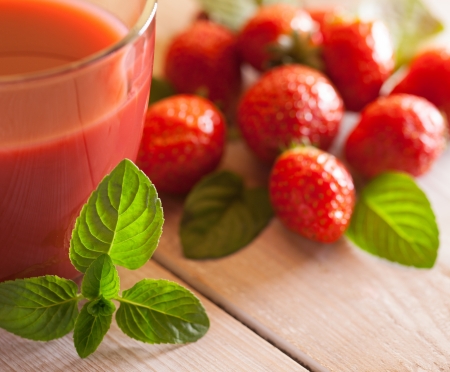 Glass of strawberry juice and strawberries in close-up.の写真素材