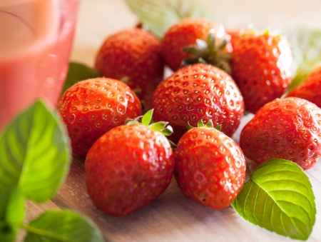 Glass of strawberry juice and strawberries in close-up.の写真素材
