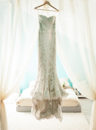 Beautiful wedding dress hanging in the bride's room.の写真素材