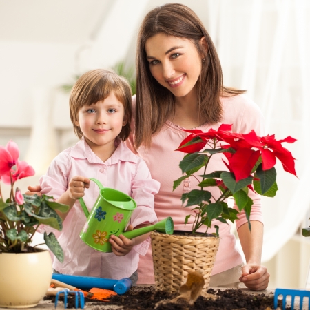 Mother and daughter watering plants together.の写真素材
