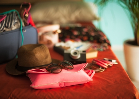 Woman's bedroom full of things ready to be taken on summer holiday.の写真素材