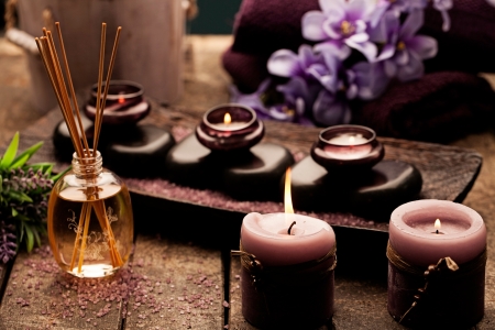 Candles, aromatherapy oil and hot stones used for spa treatments.の写真素材