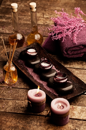 Candles, aromatherapy oil and hot stones used for spa treatments.の写真素材