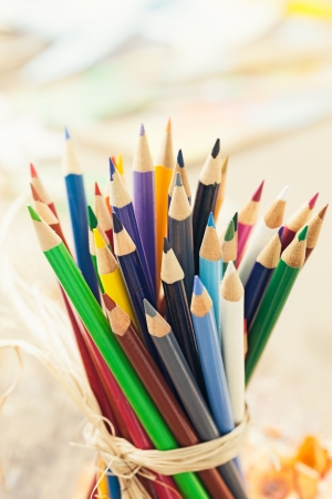 Bunch of coloured pencils tied together in close-up.の写真素材