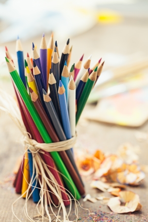 Bunch of coloured pencils tied together in close-up.の写真素材