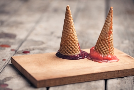 Two cones with fruit sorbet turned upside down.の写真素材