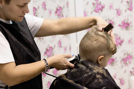 Small boy during a haircut at hair salon.の写真素材