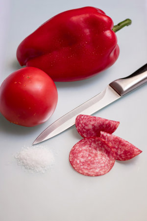 Slices salami with vegetables and salt.の写真素材