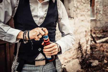 Unrecognizable man opening beer bottle.の写真素材