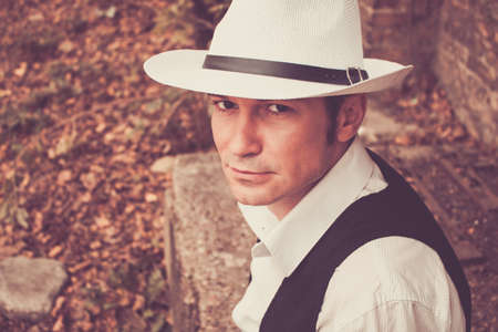 Portrait of confident man with fedora hat looking at camera.の写真素材