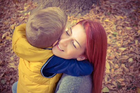 Loving mother and son embracing each other in nature.の写真素材