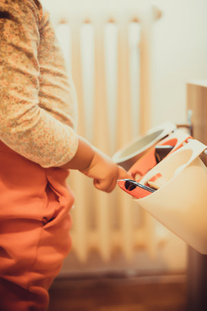 Unrecognizable kid choosing toys while playing at home.の写真素材