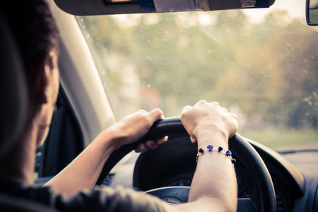Close-up of woman driving car while traveling.