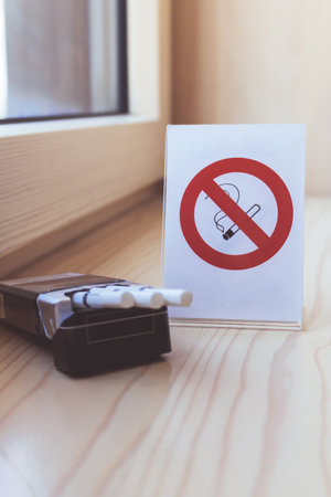No smoking sig with pack of cigarette on a window sill.の写真素材