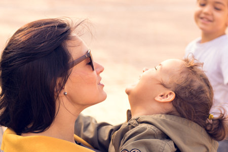 Joyful little girl having fun with her mom. Happy mother and daughter enjoying in time together.の写真素材