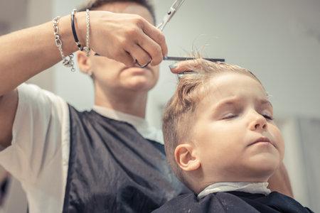 Little boy getting a haircut at barber shop.の写真素材