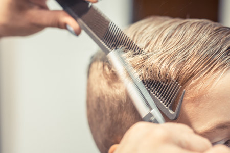 Close up of little boy getting a haircut.の写真素材