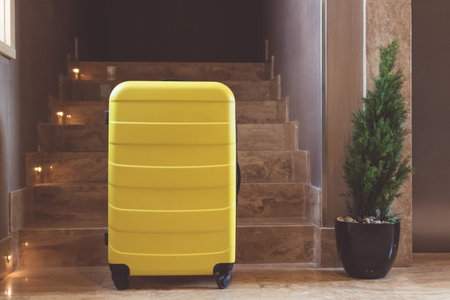 Yellow travel bag in a lobby.の写真素材