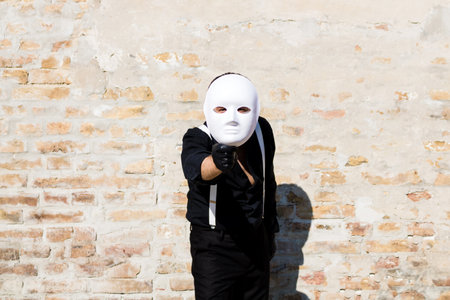 Unrecognizable man looking at camera through the mask.の写真素材