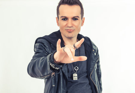 Close up of man showing horn sign.の写真素材