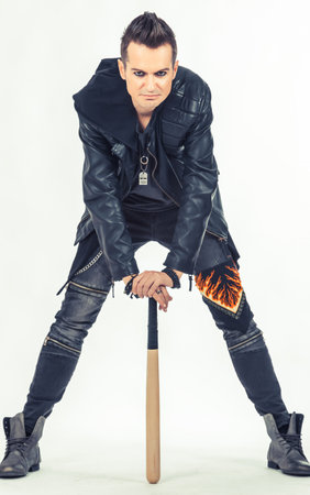 Displeased metalhead with a baseball bat on white background.