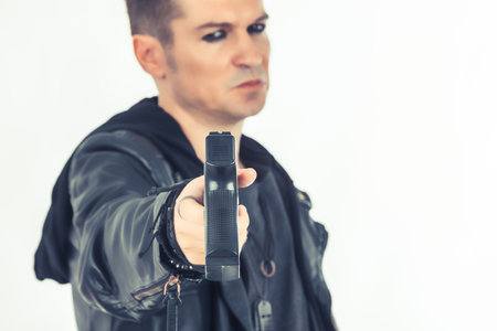 Close-up of man handing over a gun.の写真素材