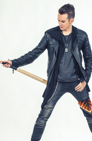Portrait of a metalhead with baseball bat on white background.の写真素材