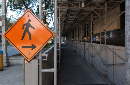 Covered scaffolding over pedestrian walkway in city center